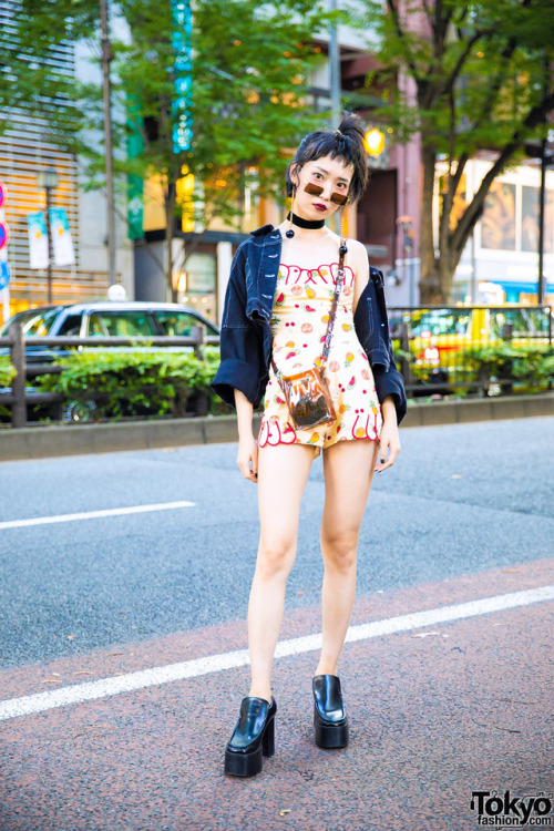 Hao on the street in Harajuku wearing a fruit print romper under a cropped denim jacket, platform sh