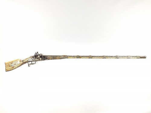 A North African snaphaunce musket mounted with ivory and decorated with silver, turquoise, and red c