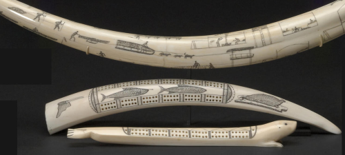 Three Eskimo scrimshaw itemsIncluding a full walrus tusk, completely engraved to depict hunting scen