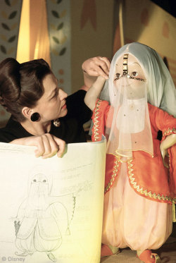 the-disney-elite:  “As a child of the Depression, I never had dolls. But thanks to Walt, I got the world’s greatest doll collection!” – Imagineer Alice Davis, shown here working on one of the many handmade costumes she created for Walt Disney’s