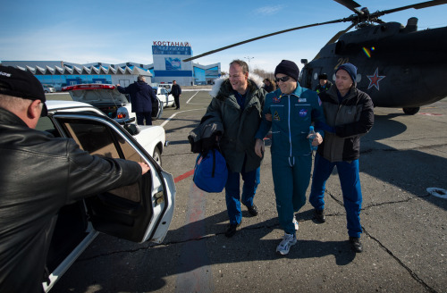 Expedition 34 Commander Kevin Ford walks (with the assistance of two NASA Flight Surgeons) from a Ru