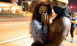 thisiseverydayracism:susiethemoderator:joryuu: thoughtsofablackgirl:  &ldquo;Love In the Time of Tear Gas.&rdquo;  Picture from Ferguson  Why aren’t we seeing this everywhere? Soooo much more meaningful than this, which was everywhere:  Those were