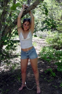 tiedupsexy2:  Last week she did an experiment and cuffed herself to a tree in the forest, (she did hide a camera in to record the experiment). In her back pocket she had a scissor and in the other pocket the keys from the handcuffs. And as someone passes