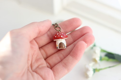 ash-elizabeth-art: This necklace features a mushroom fairy house with a little door and some flowers