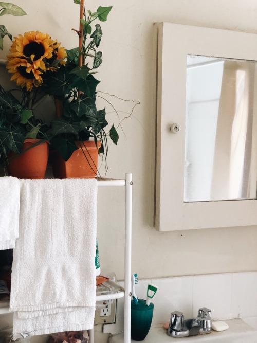 crescentwords:my grandma’s sunflower bathroom featuring my thinking journal, a cup of hot coff