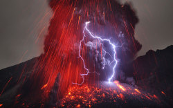 inothernews:  Sakurajima volcano in southern Japan is seen mid-eruption in January 2013 — with lightning flashes occurring near its summit.  Why lightning occurs even in common thunderstorms remains a topic of research, and the cause of volcanic lightning