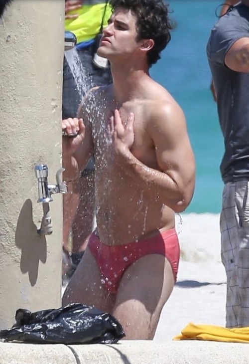 celebritybodybuge:  Darren Criss Part 1 Darren Criss in a red speedo as Andrew Cunanan on the set of The Assassination of Gianni Versace; American Crime Story.