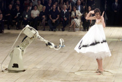 fashiondestruction92: Runway shows often blur the line between straight fashion and performance art, and Alexander McQueen was a master at both. For his Spring 1999 show, a ravaged-looking Shalom Harlow entered the runway in a plain white dress, and stood