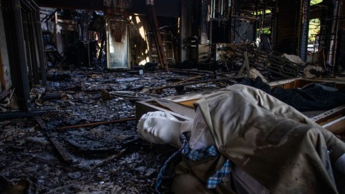 A mannequin is seen on the floor of a burned shop in Downtown Long Beach, California on June 1, 2020