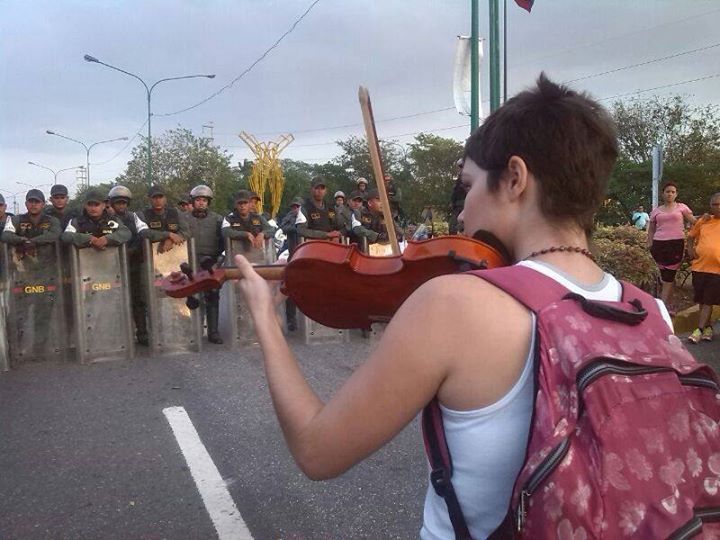 vanu:  Violinist playing our National Hymn to the GNB during a Protest.Venezuela