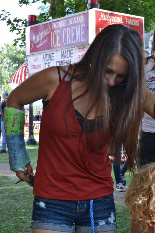 MMA fighter at a festival with a broken wrist.  Half blue half green SAC.  Pretty well bea