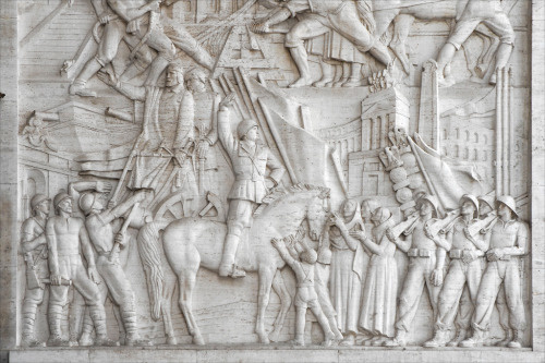Marble relief at the Palazzo degli Uffici showing Mussolini, circa World War II.