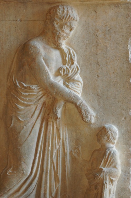 Funeral stele of Pentelic marble, showing the deceased taking leave of his young son.  Artist unknow
