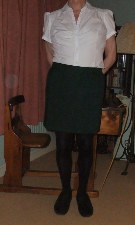 Caroline had dressed Jennifer in her bottle green school skirt with black tights and a white sixth f
