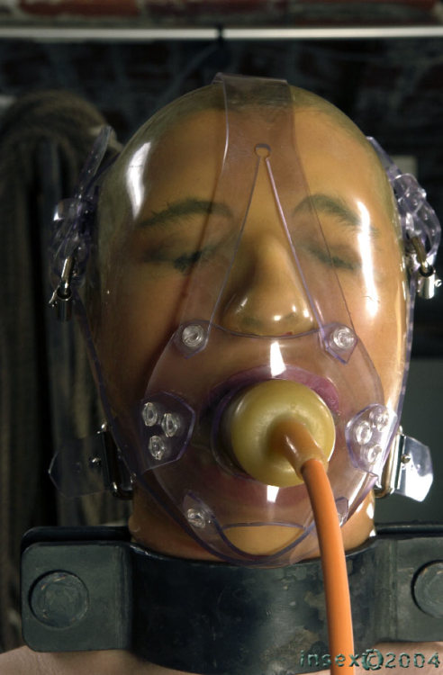 mouthlock: What’s better than a latex hood? A latex hood with a muzzle gag and some heavy iron