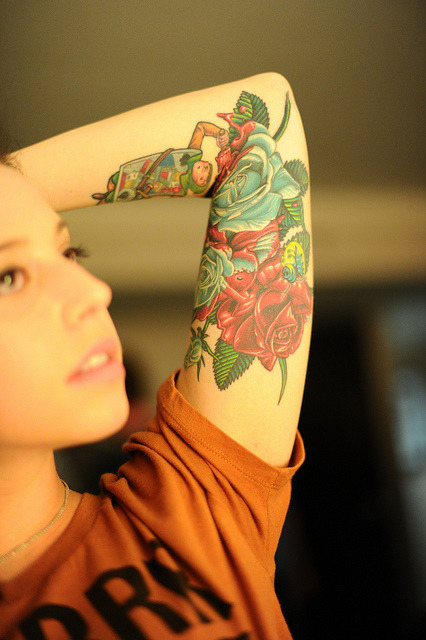 Upper arm rose tattoos for women