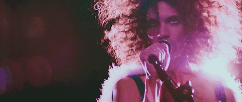 Danny's eyes are intense while he sings into a microphone and bobs to the rhythm.