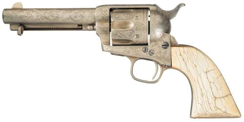 An engraved Colt Model 1873 Single Action Army with ivory grips.  Owned by a man named Timothy I. Co