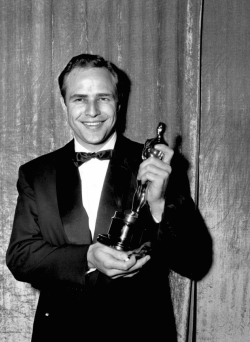 marlonbrando:  Marlon Brando holding his Best Actor award at the 27th annual Academy Awards, 1955.