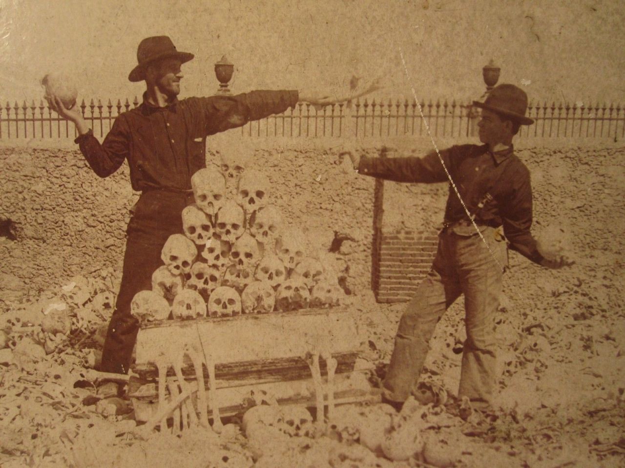 sixpenceee:  American soldiers playing around with human skulls in Colon Cemetery