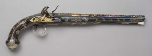 Gold inlaid flintlock pistol crafted by Bennet and Lacey of London.from The Philadelphia Museum of A