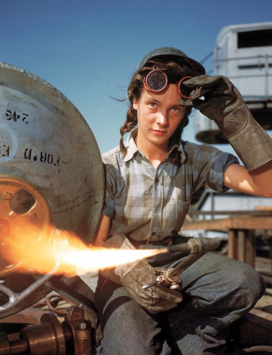 speciesofleastconcern: A young female welder adjusts her goggles, Groton, Connecticut, 1943. Photograph by Bernard Hoffman. 