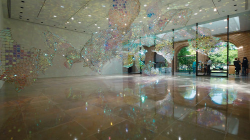 Soo Sunny Park (b. Seoul, Korea) - Unwoven Light at Rice University’s Rice Gallery in Houston, Texas. Composed of 37 individual sculptural units, the installation uses iridescent plexi-glass embedded in pieces of a chain link fence to cast shimmering,