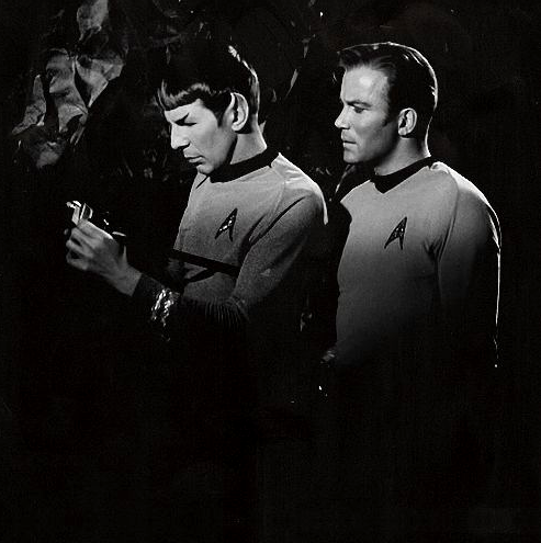 vulcankisseshuman:Spock doing science stuff and Kirk standing behind him, pretending to be all capta