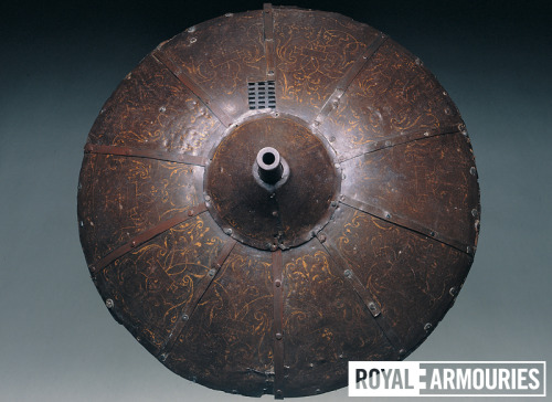A shield outfitted with a gun that was owned by King Henry VIII of England.Currently a part of the R