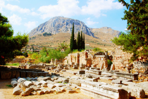 ancientromebuildings: miiiiiiiich: The ruins of Ancient Corinth, overlooked by the Temple of Aphrodi