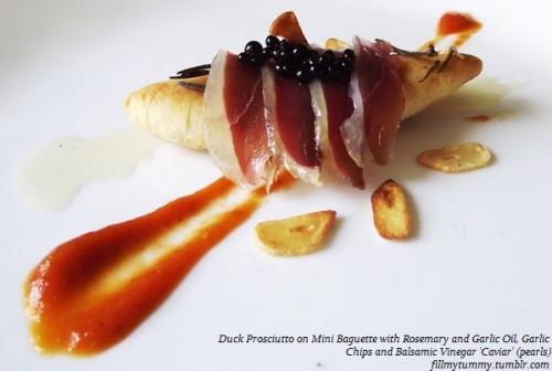 fillmytummy:  Duck prosciutto on miniature baguette with rosemary and garlic oil, garlic chips and Balsamic Vinegar “caviar” served with roasted tomato puree.That’s right…. little pearls of balsamic vinegar. 