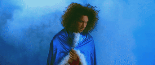 Seven gifs from the "Danny Don't You Know" music video. In the first gif, Danny Sexbang is holding his blue cape around his shoulders and lifting his head to sing.