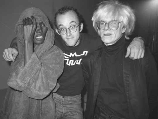 Grace Jones, Keith Haring and Andy Warhol, filming for the “I’m Not Perfect” music video, 1986. Photo: Tseng Kwong Chi. © Muna...