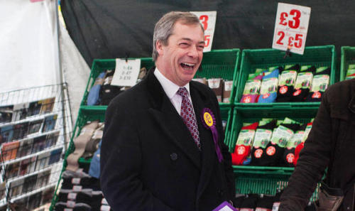 Nigel laughing at a market seller for the desperate state of their sock collection and CD rack.