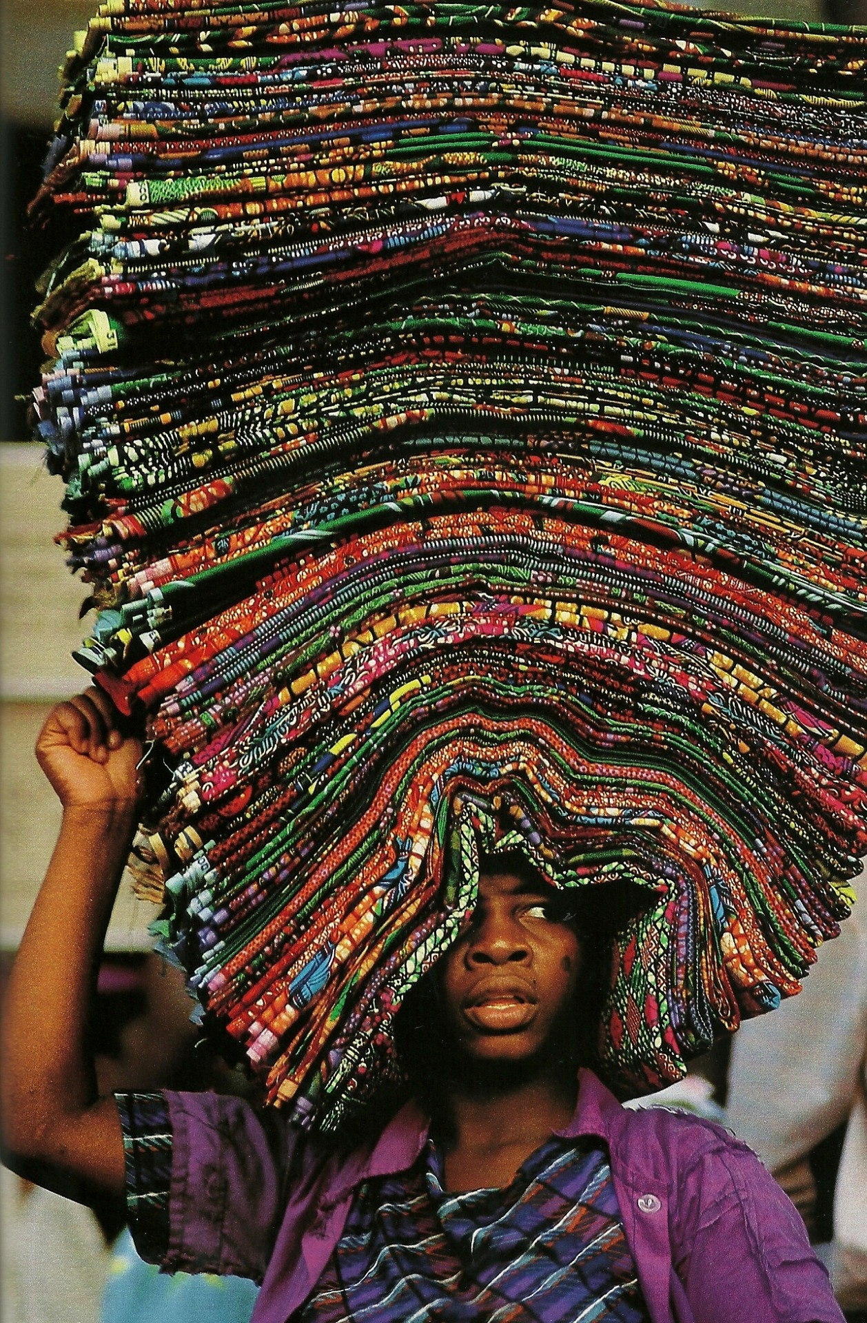 vintagenatgeographic:  A vendor peddling wax prints in Lome, Togo National Geographic