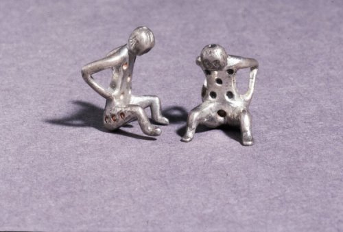 ancientpeoples:Silver Dice in the form of Squatting Figures with red spotsRoman1st-2nd Century ADhei