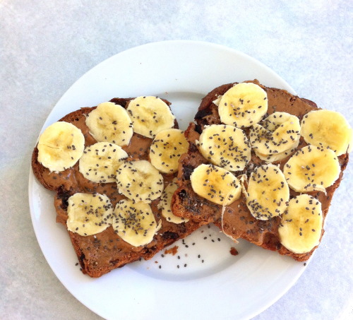 addictedtofruit:  Post-Workout/Lunch; 2 slices of cinnamon raisin ezekiel bread topped with almond butter, banana slices, & a sprinkle of chia seeds  at first i thought they were ants
