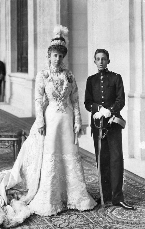 María Cristina, Queen of Spain, with her son Alfonso XIII, wearing a day dress with lapels and long 
