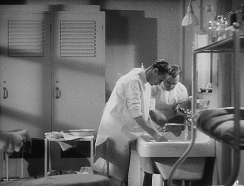 moviehospital:leslie howard (medical student) and colleague scrub and then proceed to smoke cigarett