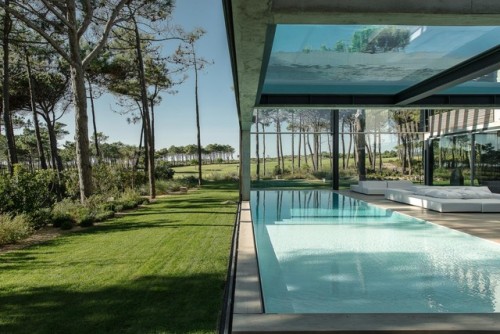 archatlas:    The Wall House by Guedes Cruz Arquitectos   Like a wall in a Castle not in stone, but in concrete, glass and wood.Not to for protection but because of the neighbours and the strong Atlantic Wind.A Patio house with a Mediterranean country