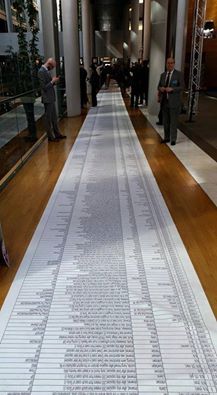 antifainternational:     The names names of 17306 migrants drowned in the Mediterranean is 100m long. Placed on floor of European Parliament.  Forcing the MEPs to walk over the people their borders have killed. Seznam 17306 uprchlíků, utonulých ve