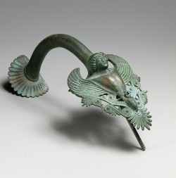 ancientpeoples:  Bronze handle of a hydria  (a water jar)  The handle is shaped like a siren, part woman and part bird. The handle is 21.3cm long (8 3/8 inch.)  Greek, Classical Period 460 - 450 BC.  Source: Metropolitan Museum