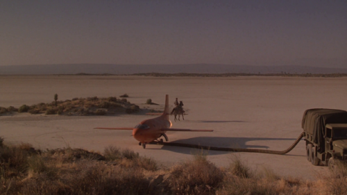 Sam Shepard, a pilot riding past the Bell X-1.