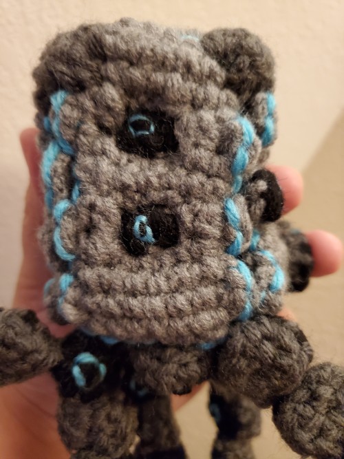 crochet pokemon stakataka with two bricks in the front flipped to show the eyes