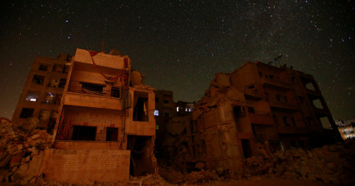 biladal-sham: Beyond damaged buildings in Idlib, Syria, a clear, starry night.Ammar Abdullah/Reuters