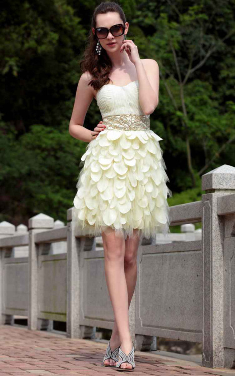 A fresh hue brings a breath of springtime to a pretty cream short homecoming dress pairing a deftly 