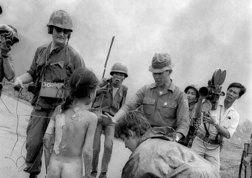 collective-history:  Television crews and South Vietnamese troops surround 9 year old Kim Phuc after she was burned by a misdirected aerial napalm attack, June 8, 1972. A South Vietnamese plane targeting suspected Viet Cong positions dropped its flaming