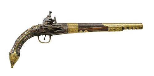 A red coral and brass decorated miquelet pistol originating from the Middle East.