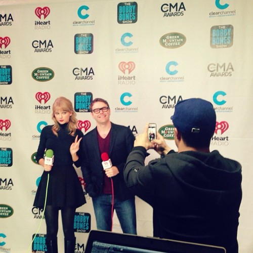 tswiftdaily:iHeartRadio: Taylor Swift strikes a pose with Bobby Bones during CMA Broadcast Week. (x)