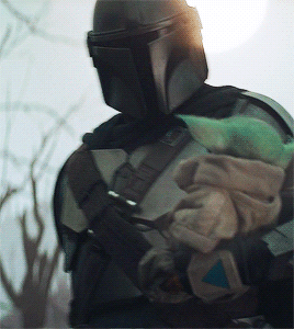 Din + Holding Baby Grogu In 2.05